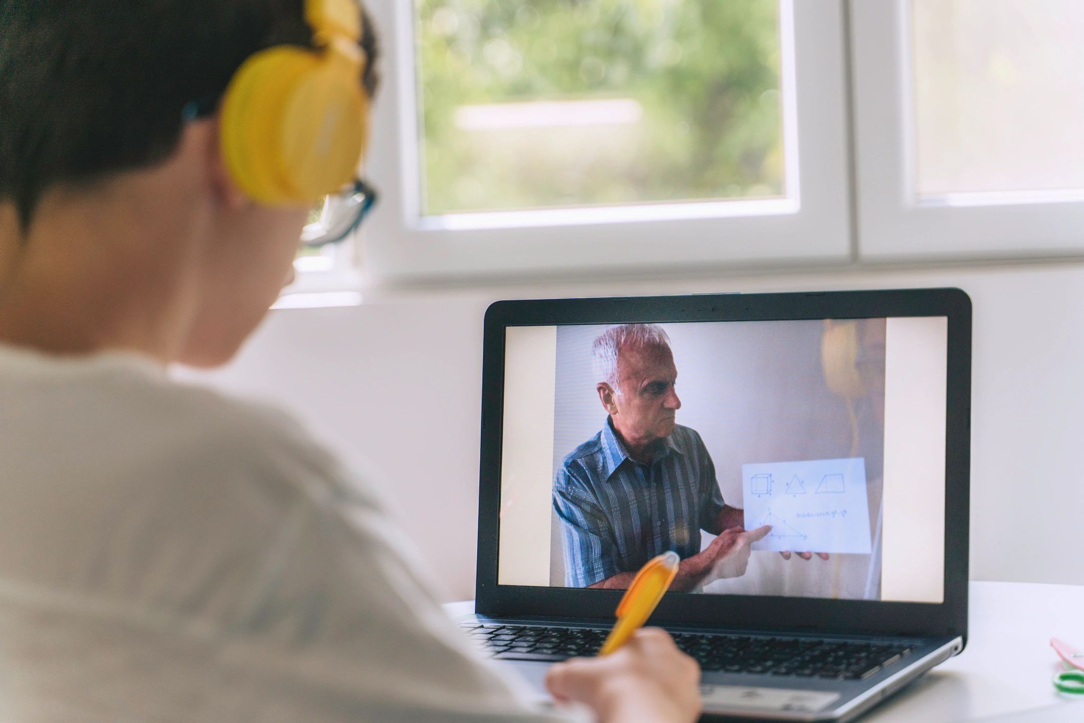 Child studying at home with a laptop